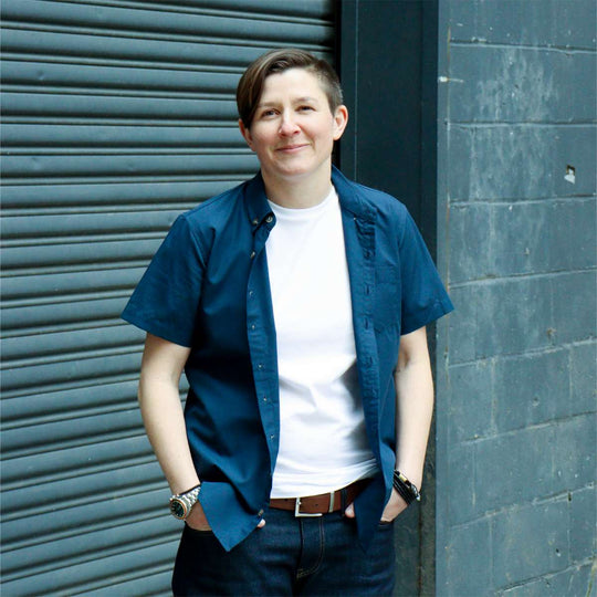 Woman modeling navy blue chambray short sleeve shirt with indigo jeans by kirrin finch
