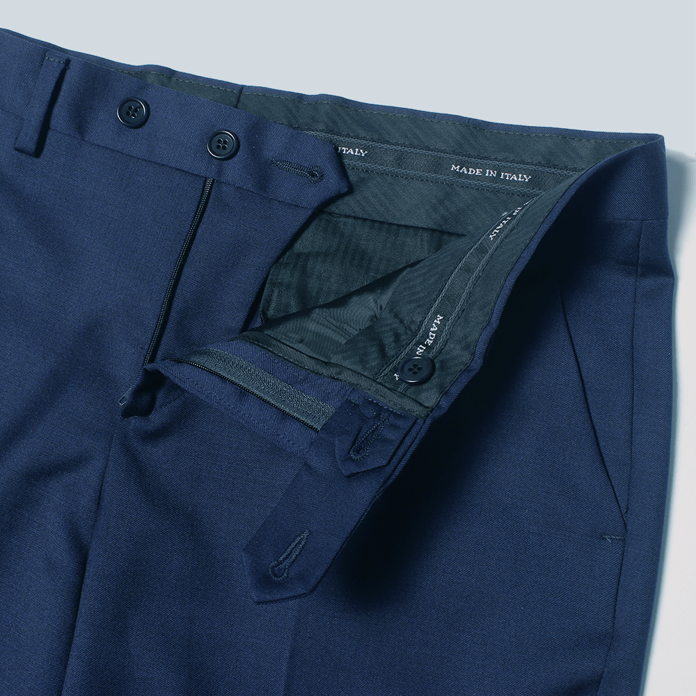Inside waistband detail of navy dress pants showing made in Italy. Color: Navy