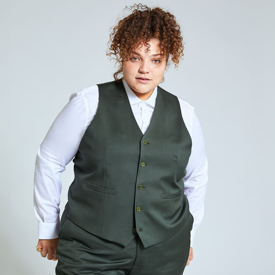 Androgynous person modeling the georgie olive vest and olive dress pants.