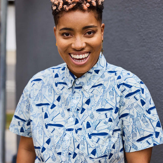 Smiling model wearing printed skateboard short sleeve shirt 