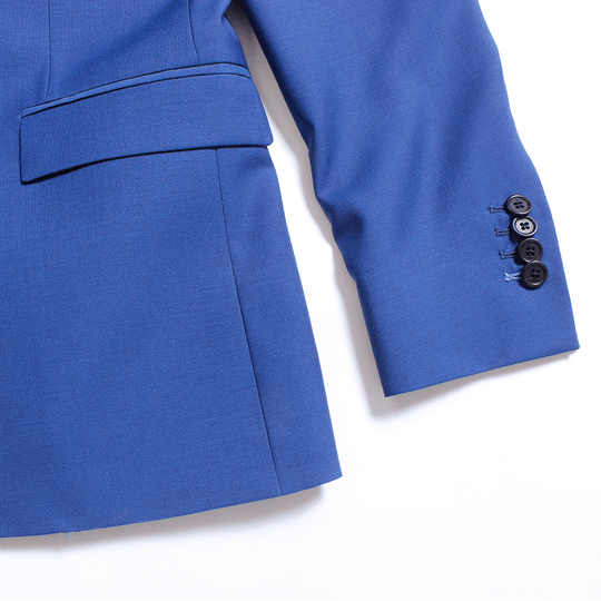 Four contrast black sleeve buttons on royal blue blazer on a white neutral background