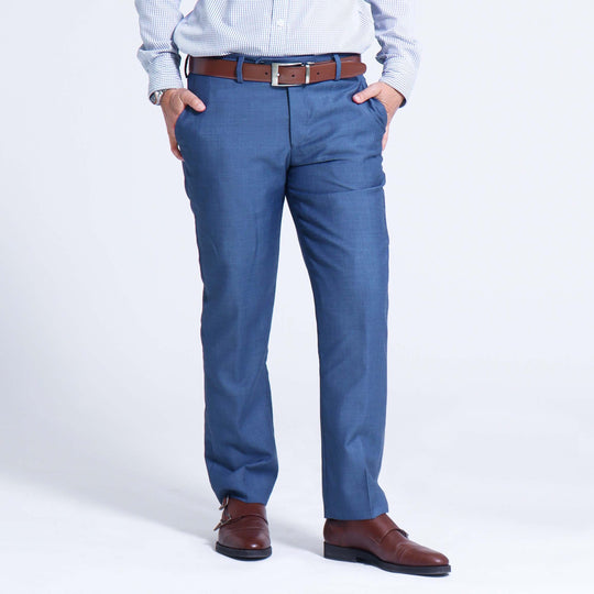 Model wearing Slate Blue Androgynous Dress pants paired with brown leather belt and shoes
