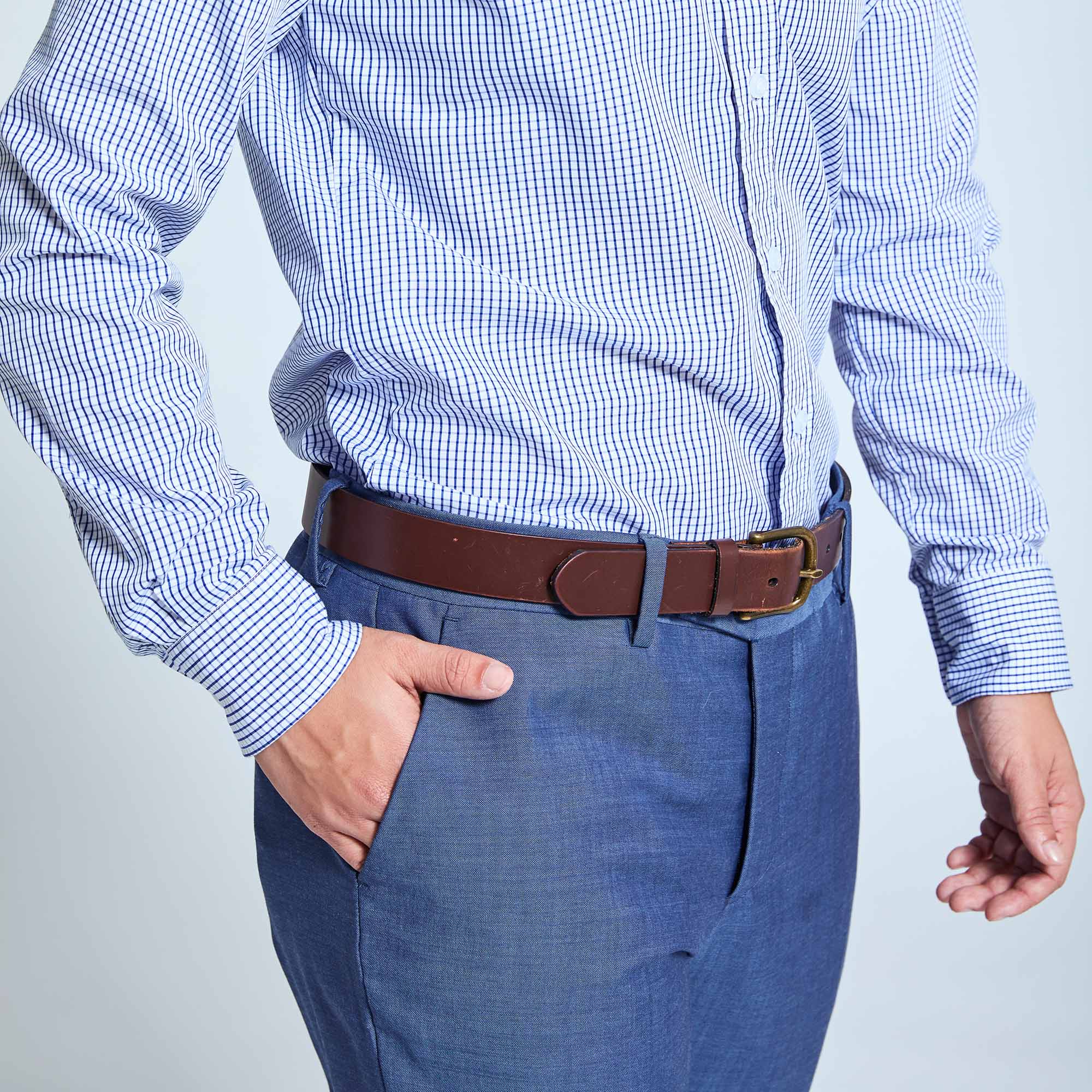 Person modeling slate blue dress pants with hand in pocket. Color: Slate Blue