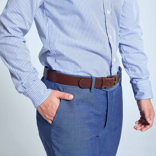 person modeling slate blue dress pants with hand in pocket