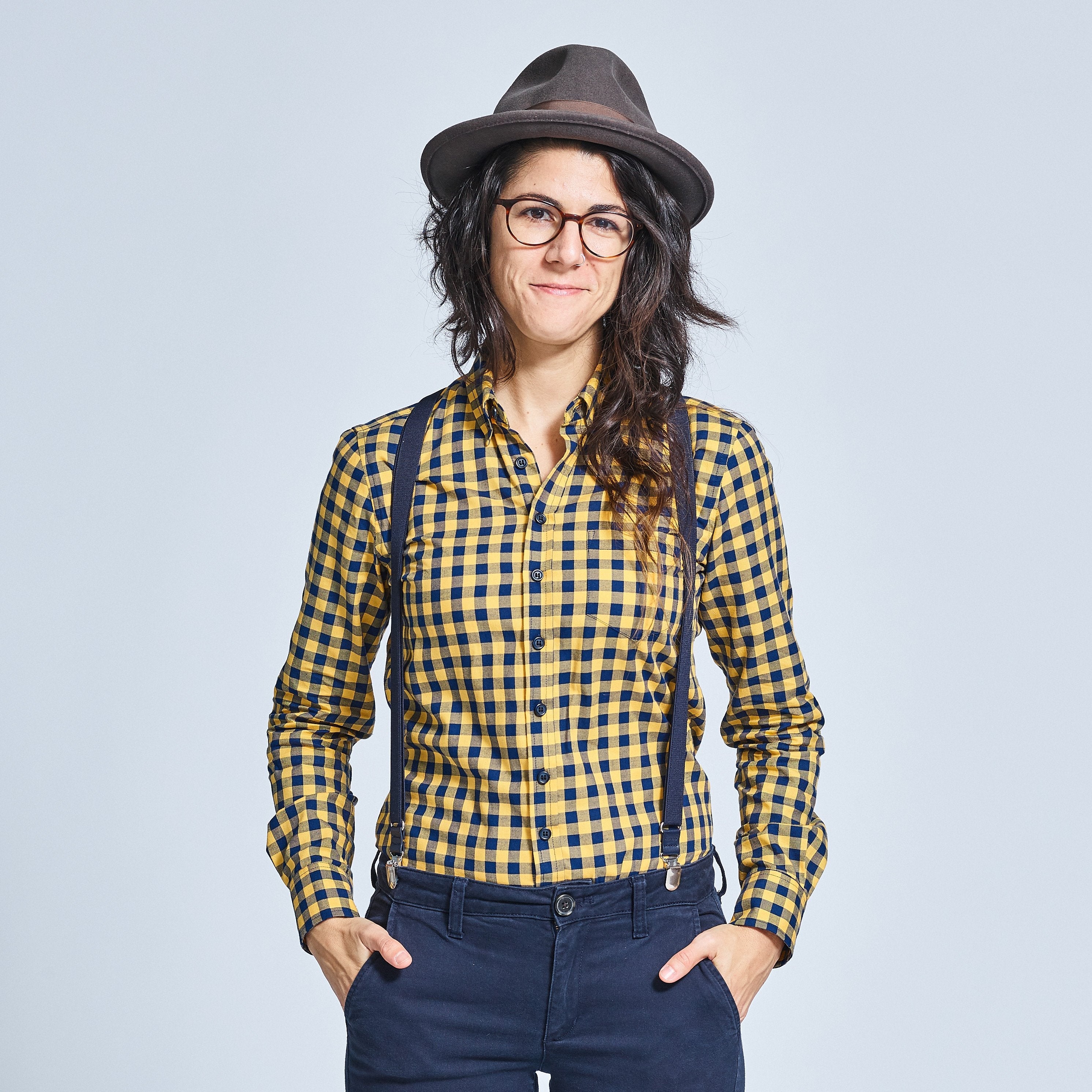 Person modeling a blue and yellow buffalo check androgynous shirt