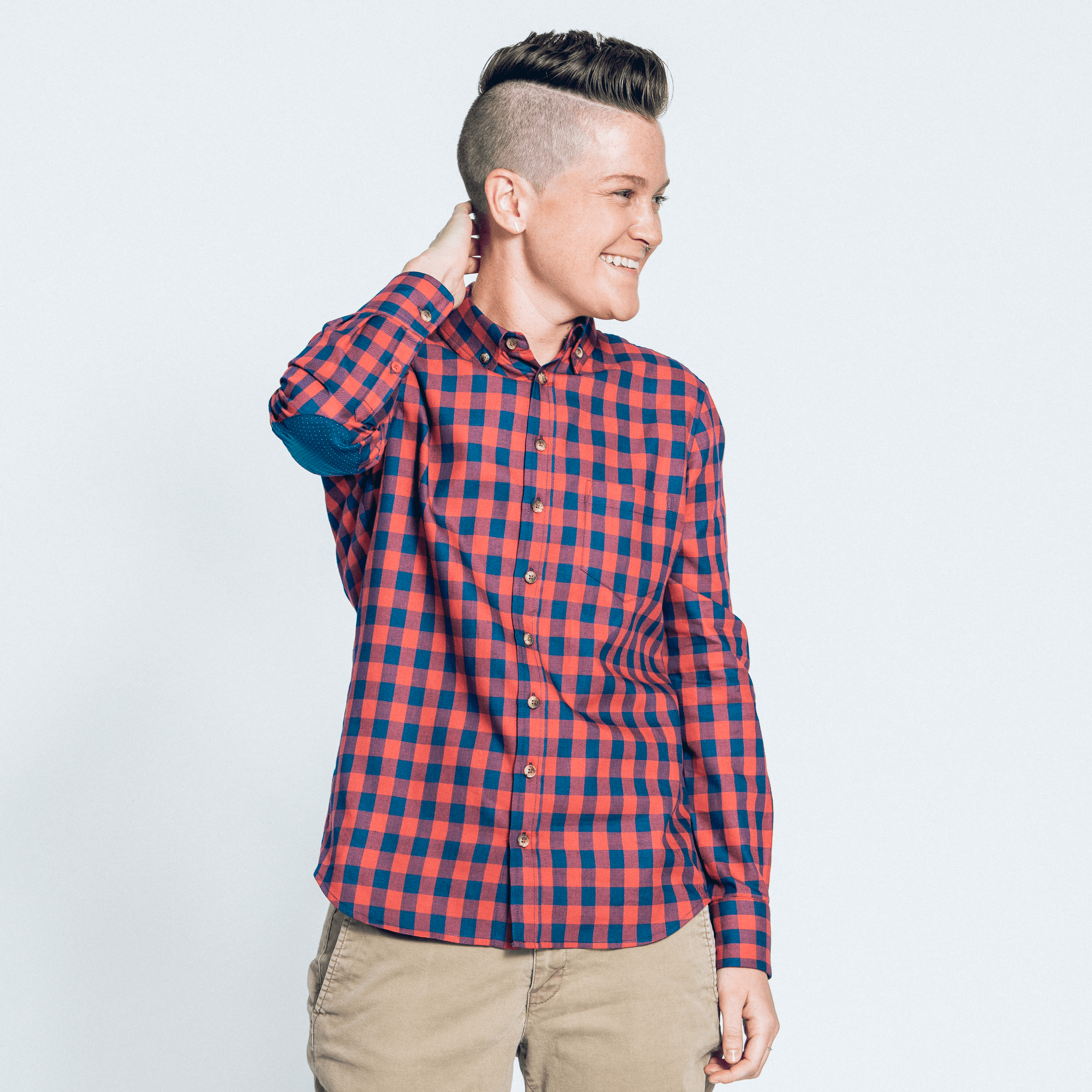 Model in red and navy check flannel by Kirrin Finch, posed with right arm on neck
